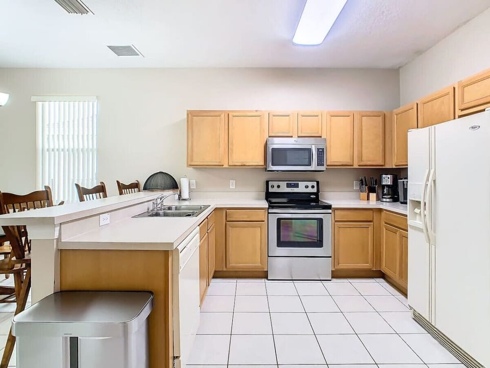 Modern, fully stocked kitchen with all the essentials for cooking and dining.
