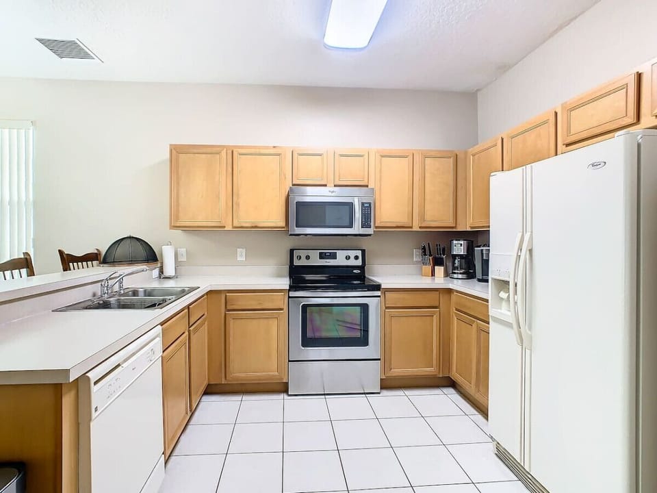 Modern, fully stocked kitchen with all the essentials for cooking and dining.