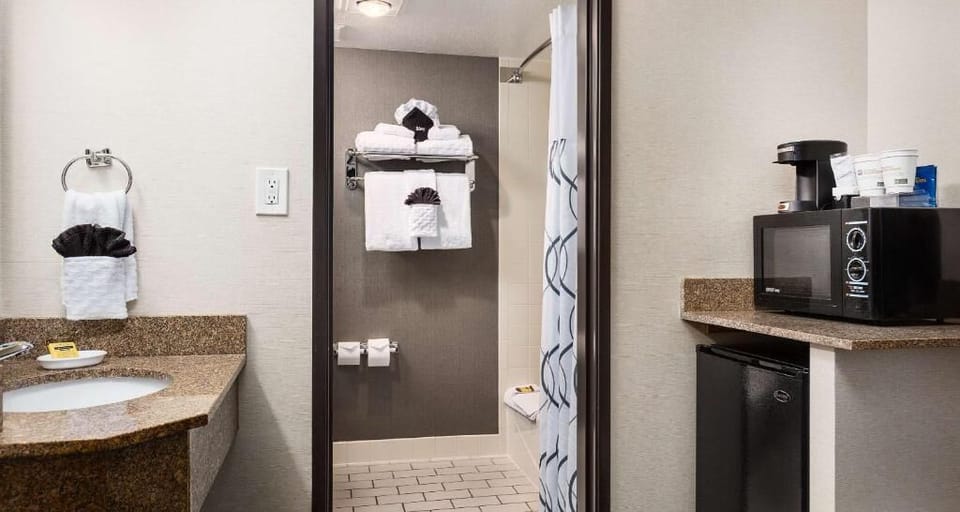Refresh after adventures with bright vanity and stocked fresh towels.