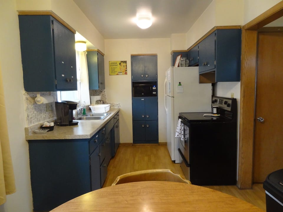 Kitchen with full stove and refrigerator