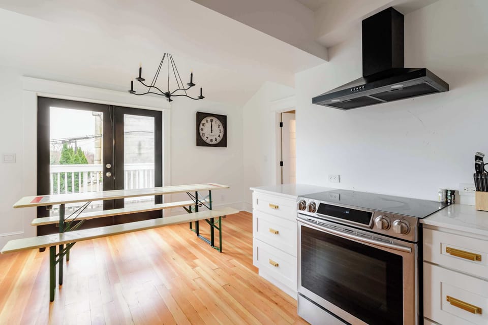 Kitchen with breakfast seating and balcony doors.
