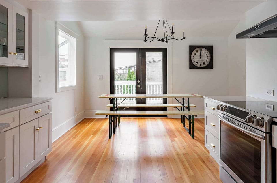 Dining room with kitchen access and bay windows.