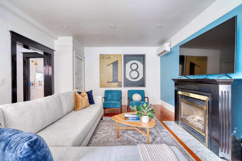 Living room with fireplace and bright blue wall.