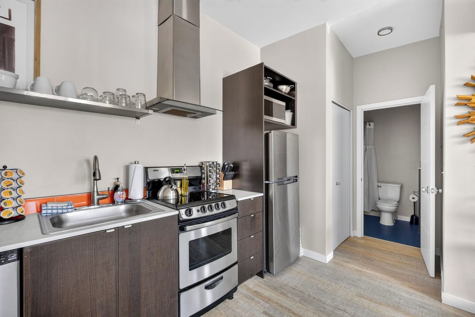 Kitchen with gas range, microwave, refrigerator, and dishwasher.
