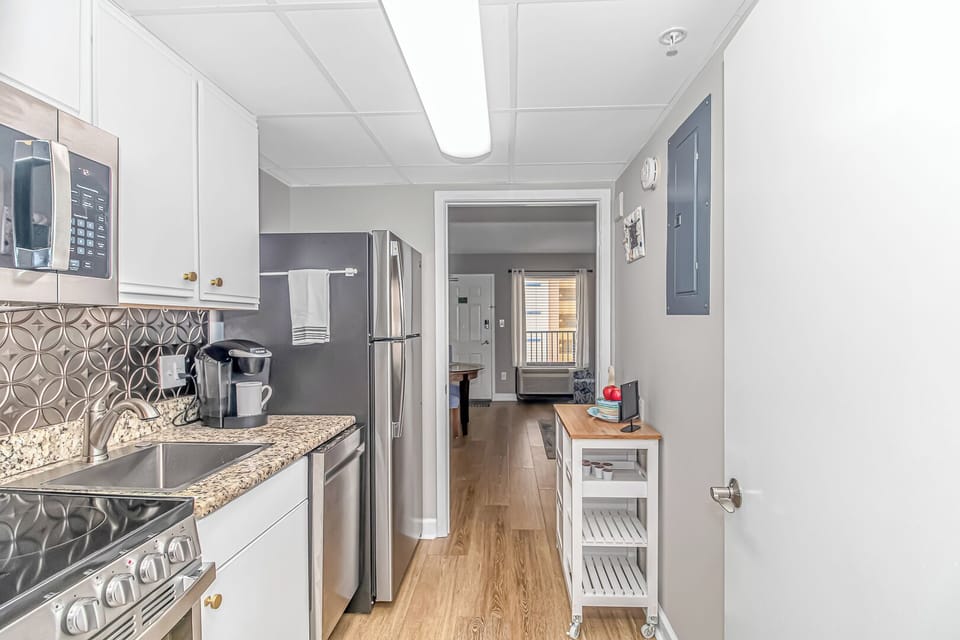 Full kitchen with stove, oven, dishwasher, and refrigerator.