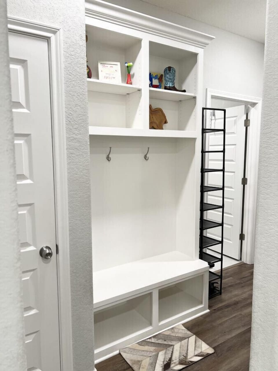 Mud room equipped with a shoe rack for easy organization.