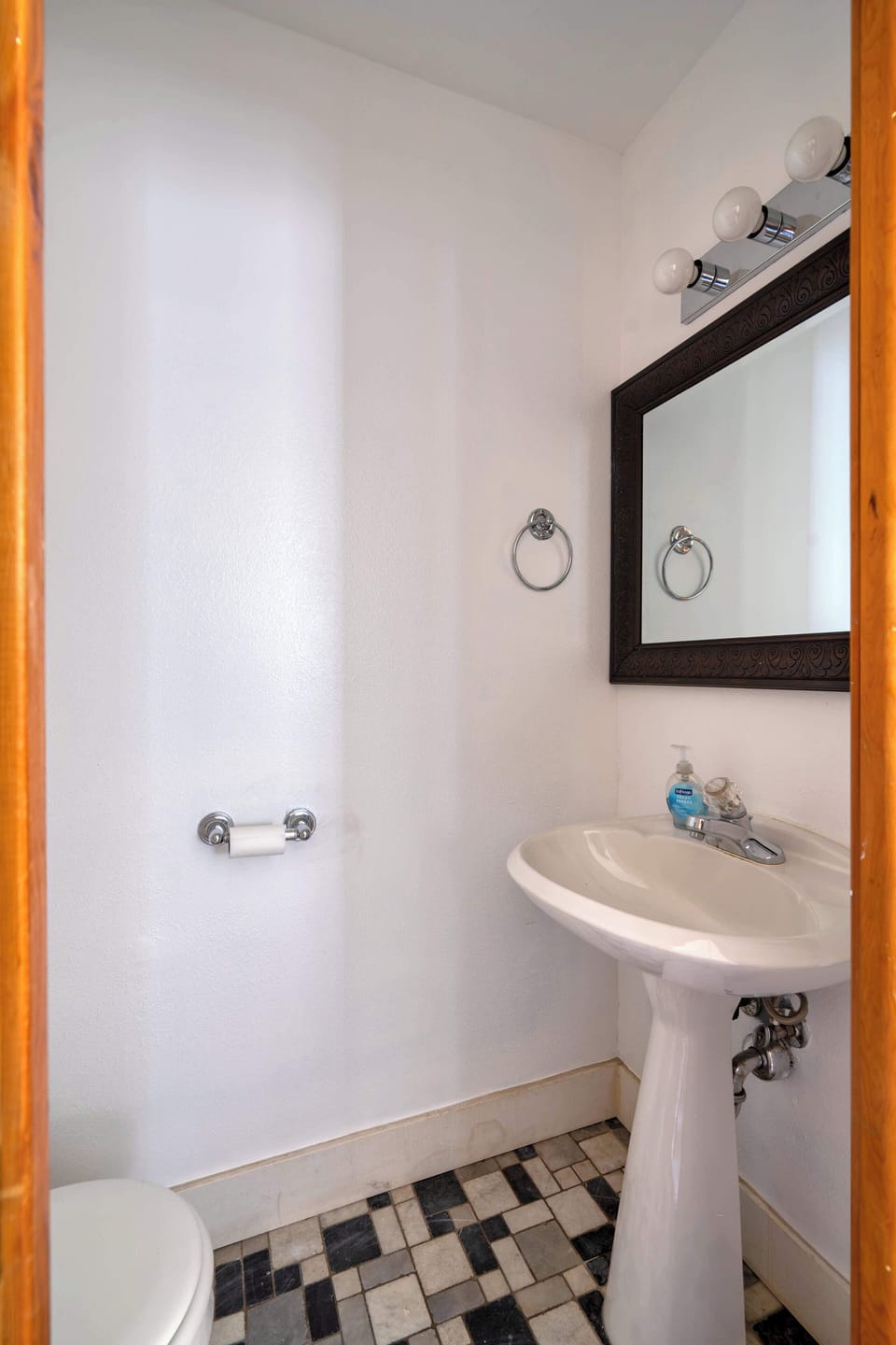 Pedestal sink and toilet in the bathroom.