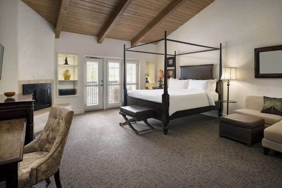 Unwind in a spacious suite with soaring beams and lounge seating.