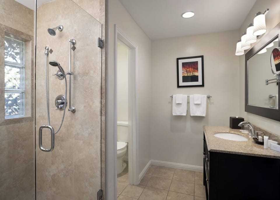 Refresh under the rainfall shower in a spotless, modern bath.