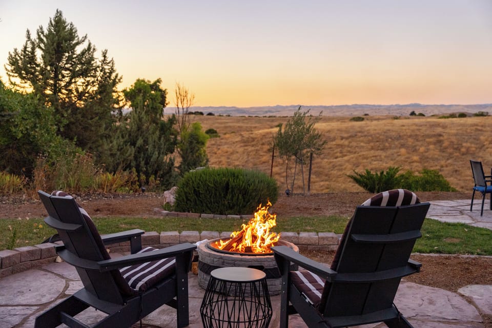 Relax in Adirondack chairs enjoying the fire pit and beautiful views of open space for miles