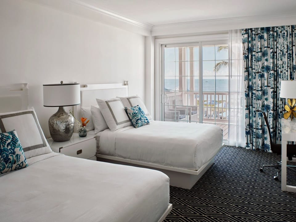 Stretch out in crisp beds with balcony doors open wide.