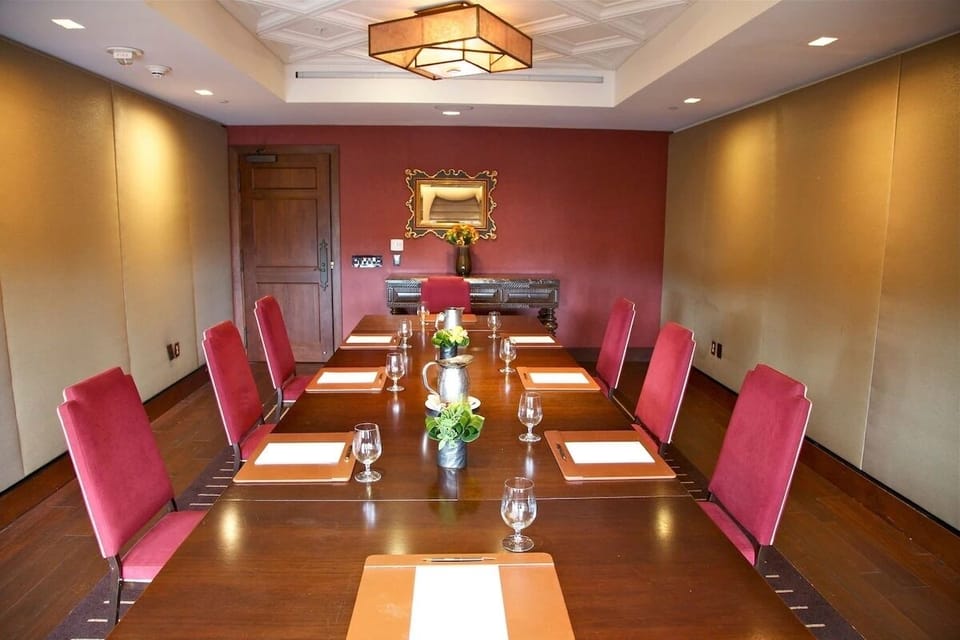 Host memorable meetings around a polished table under warm lighting.