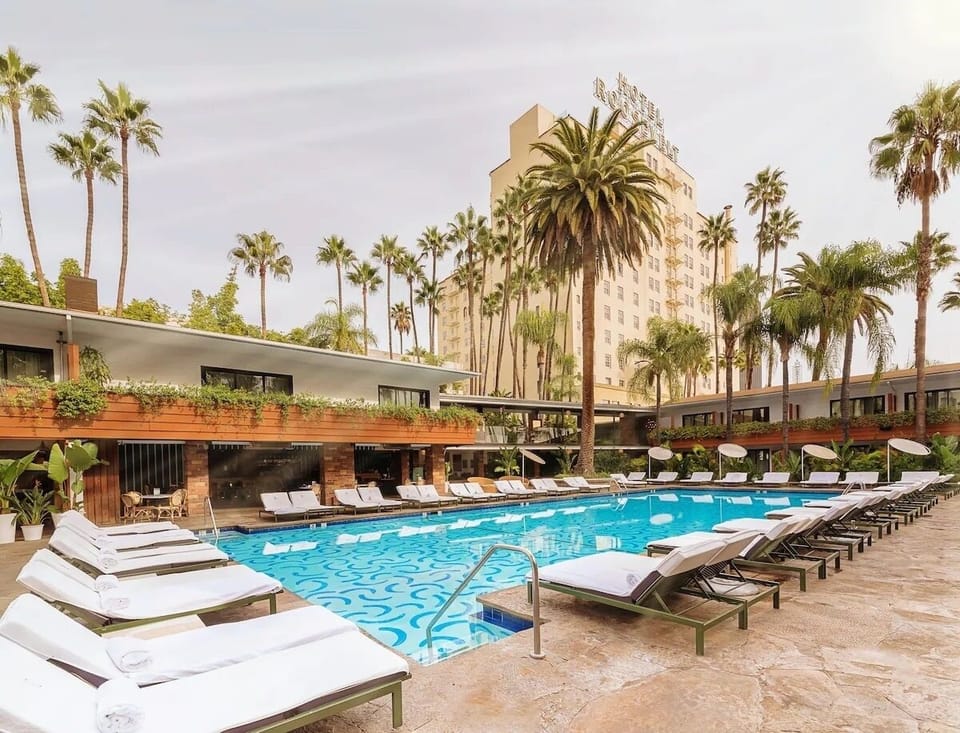 Stretch out on plush loungers beside the sparkling turquoise water.
