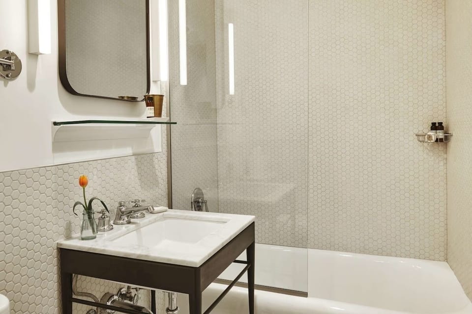 Soak and reset with a clean tub and bright vanity.