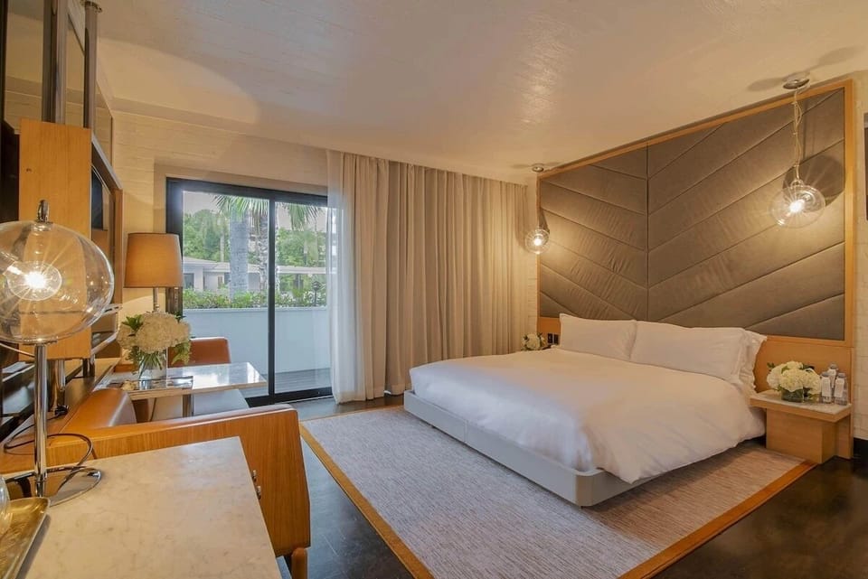 Unwind in a sunlit king room with private balcony views