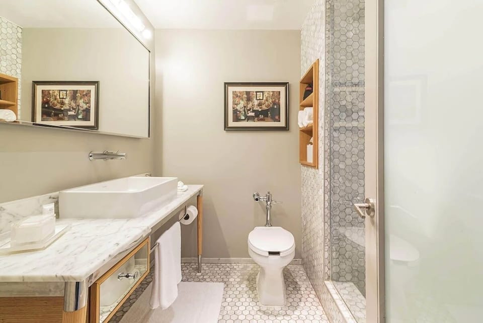 Refresh in a spotless bathroom with marble vanity and walk-in shower