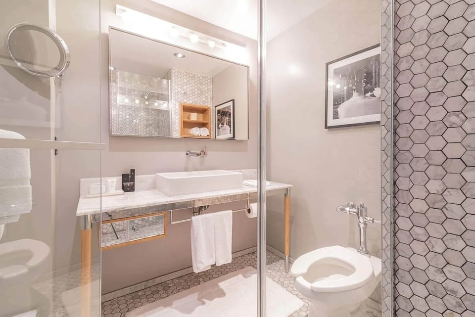 Prepare with ease at a bright vanity and sleek tiled shower