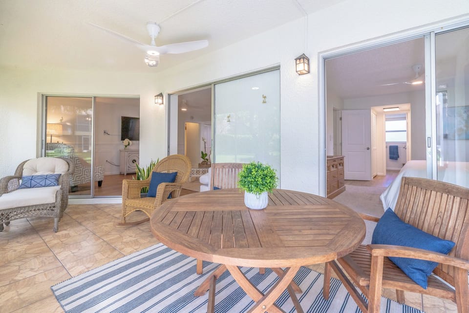 Lanai with teak wood table and chairs, rocking chair, lounge chair with chaise