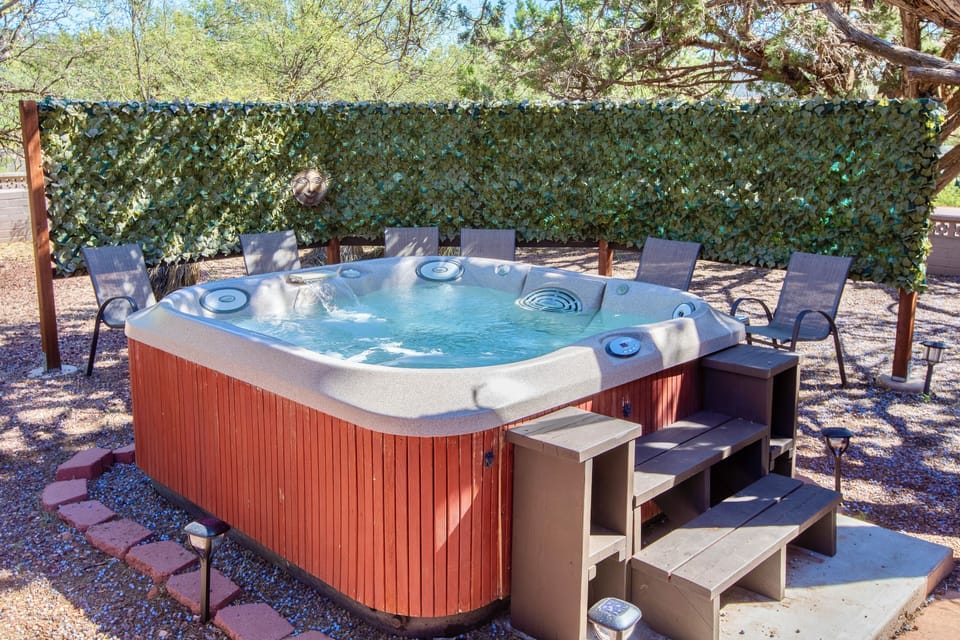 Enjoy our semi-private hot tub area in the backyard with 6 chairs + tables.