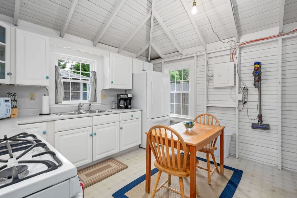 Have a seat at the dining table for two or use it as additional prep space as you take your meals out to the screened porch - 17 Captain Dunbar Road Brewster Cape Cod-Prestons Haven-NEVR