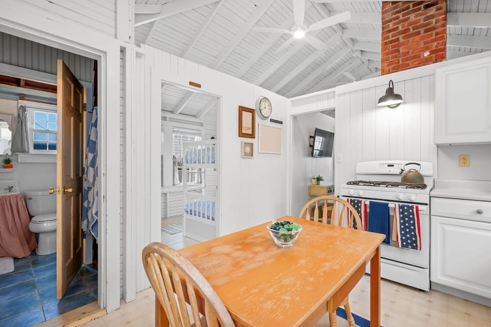 View from kitchen toward bathroom, bunk room and living room beyond - 17 Captain Dunbar Road Brewster Cape Cod-Prestons Haven-NEVR