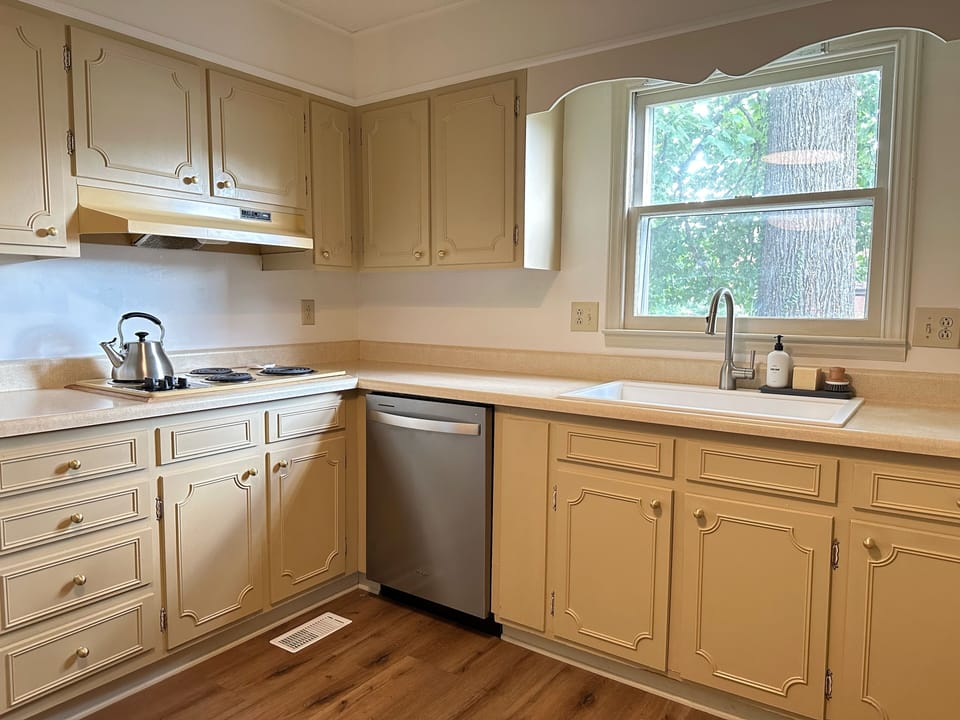 Kitchen stocked with plenty of dishes for four and essentials.