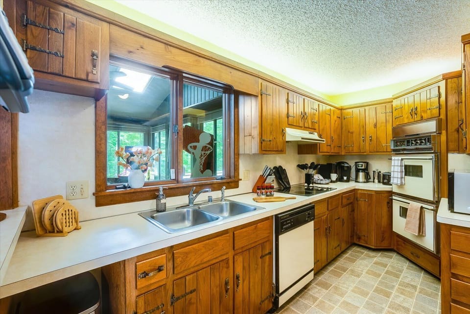 Step into culinary paradise in our fully stocked kitchen, boasting an abundance of cabinetry that holds endless possibilities for your cooking adventures