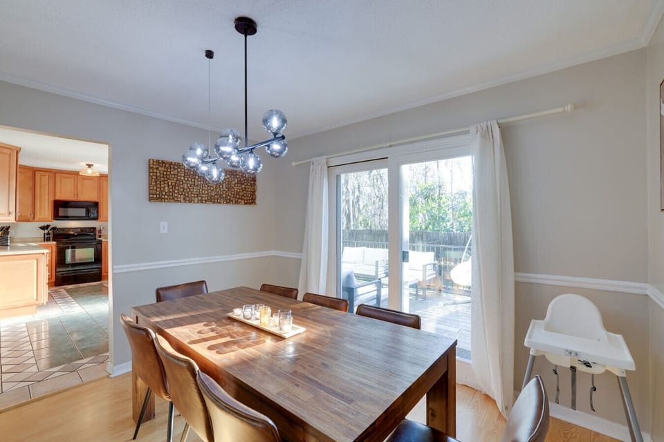 Enjoy meals in this beautifully lit dining space with a modern chandelier and direct access to the backyard.