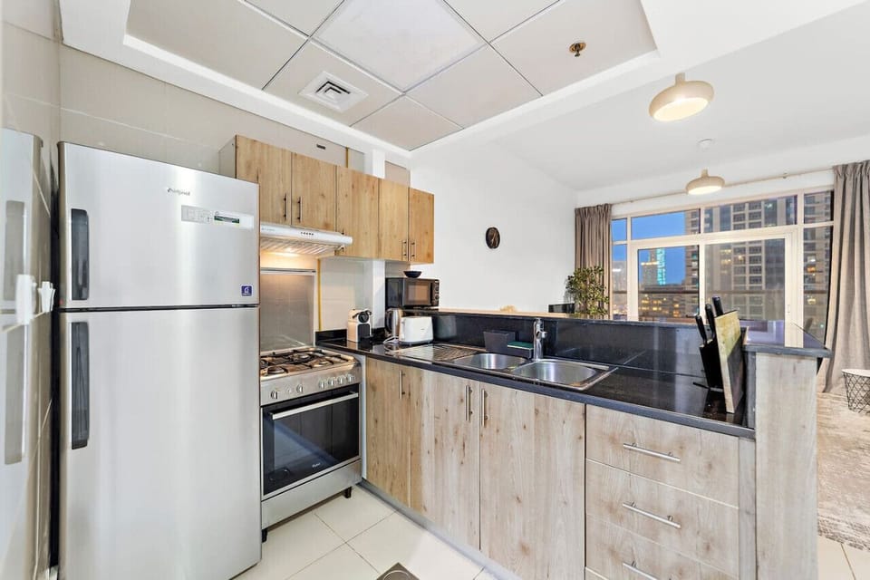 Kitchen: Modern culinary haven with sleek appliances and city views for delightful cooking adventures!