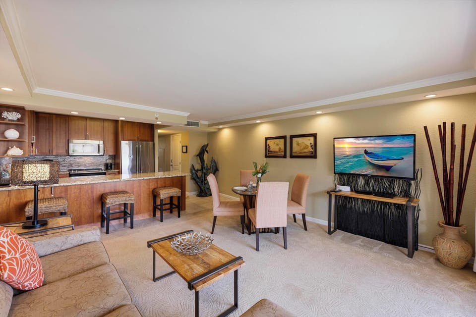 This beautifully designed open-concept living space features a fully equipped kitchen, elegant dining area, and cozy lounge with a smart TV—perfect for a relaxing Maui getaway.