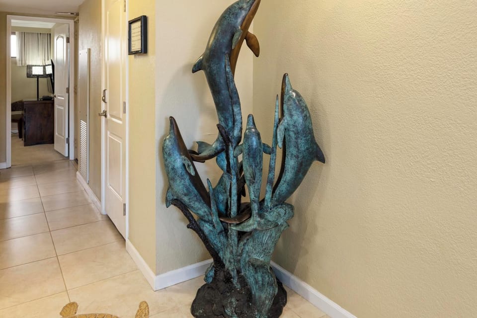 This stunning bronze dolphin sculpture adds a touch of island elegance to the space, capturing the essence of Maui's marine beauty.