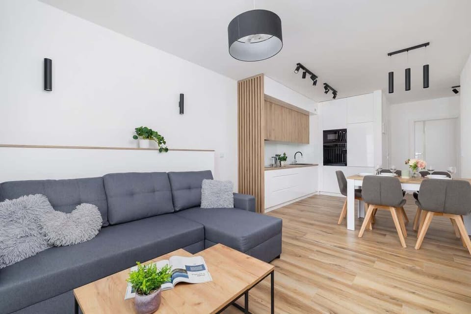 The elegant living room featuring a double sofa bed, perfect for relaxing or sleeping.