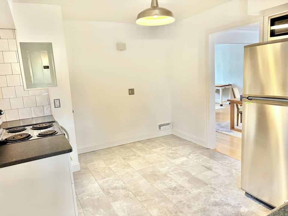 Stainless steel appliances, tile floor, artisan tile backsplash, stone counters