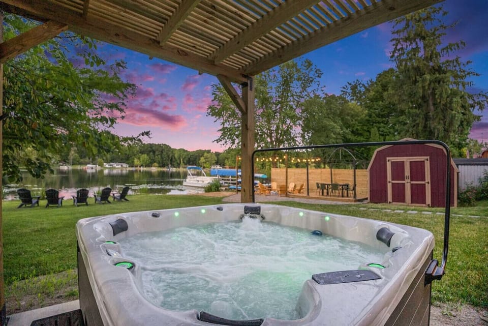 Relax and unwind in the hot tub while enjoying the scenic lake view.