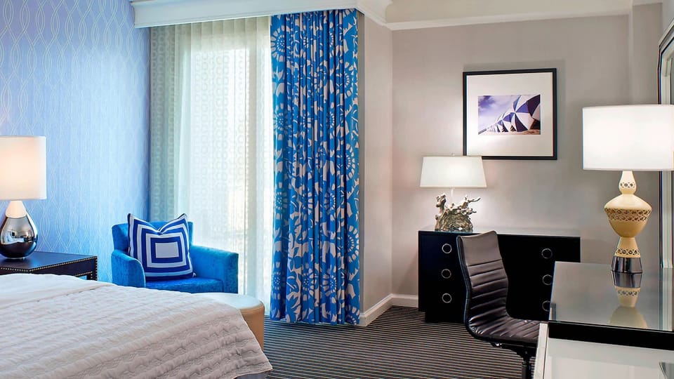 Settle into chic comfort with a dedicated desk and plush bed.