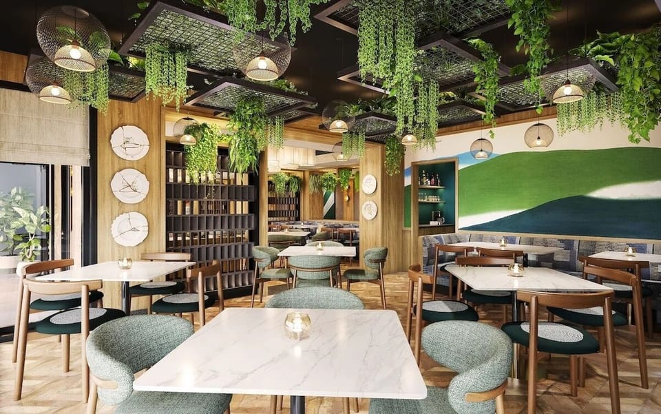 Linger over breakfast in a vibrant dining room with hanging plants.