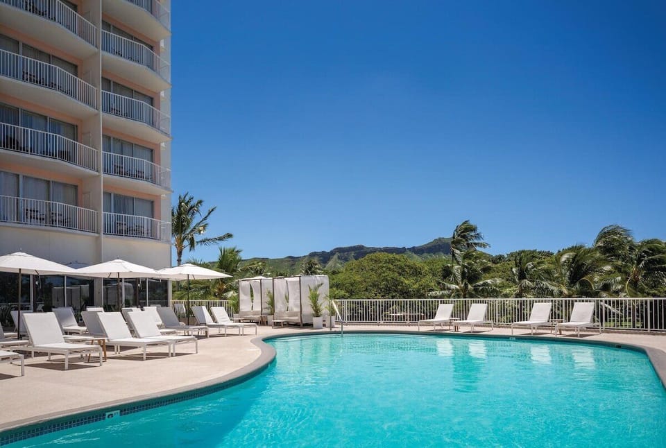 Stretch out on chic loungers beside the sparkling resort pool.