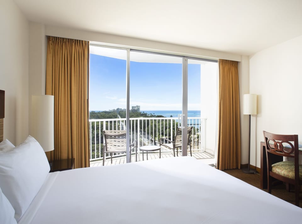 Recharge in sunlit comfort with balcony seating and open views.