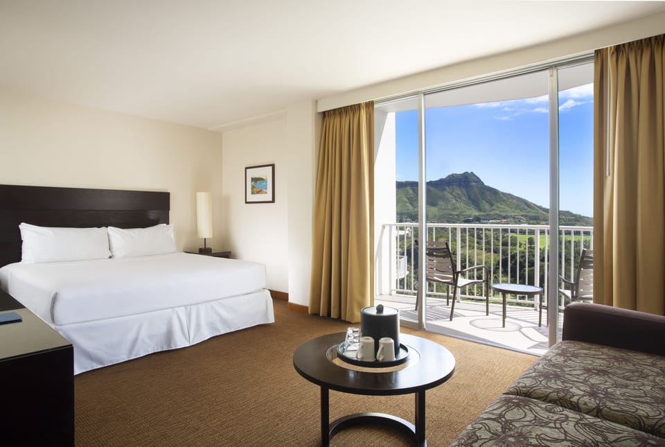 Unwind in crisp, cloud-soft bedding with balcony breezes.