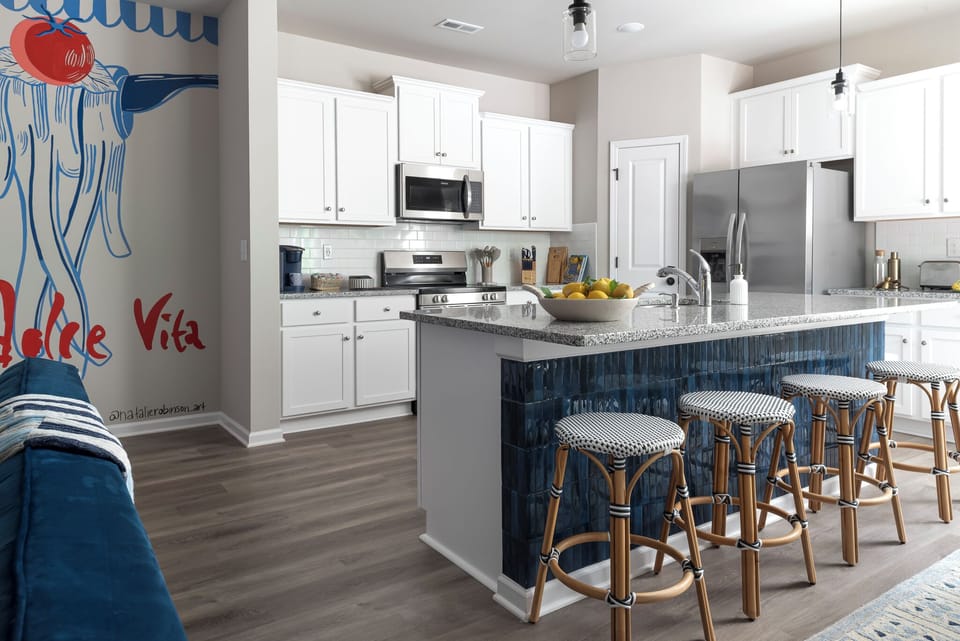 The kitchen island has bar seating for 4