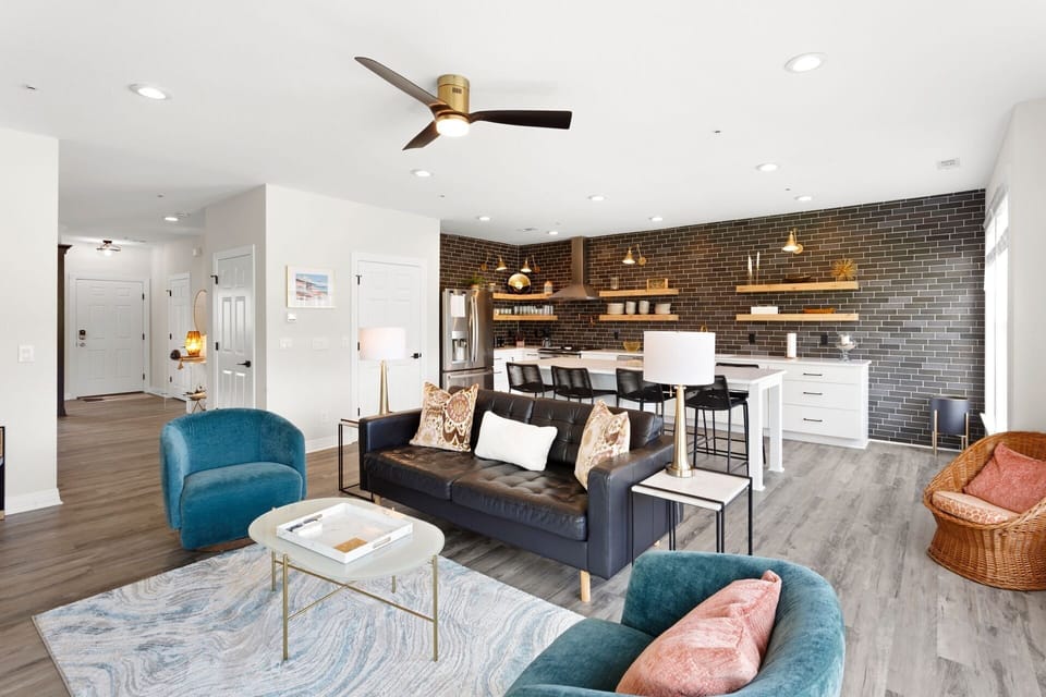 Relax in this spacious Living Area with a large Flat Screen TV and lots of brilliant, natural light.