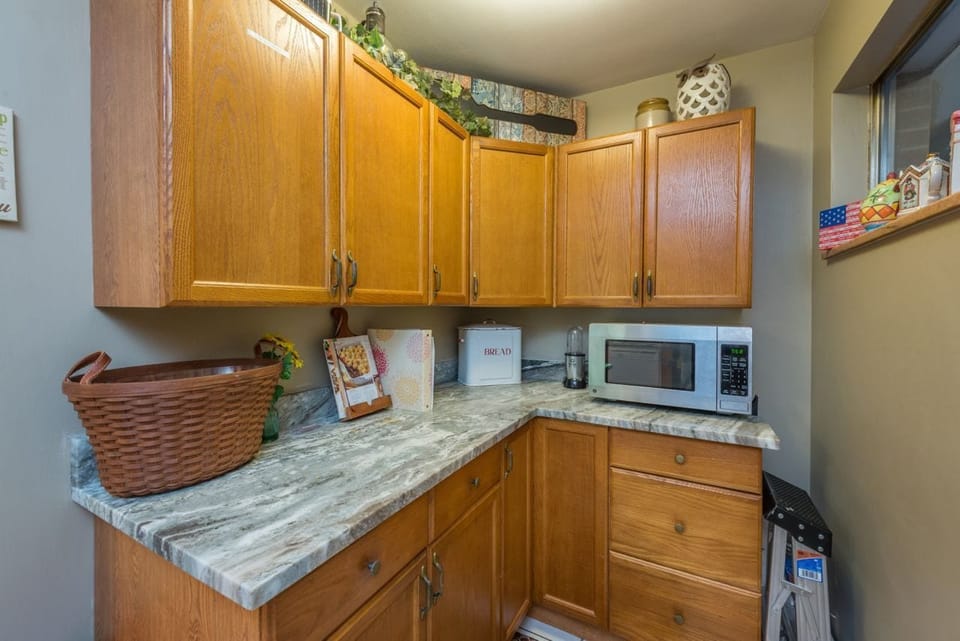 Additional kitchen nook with extra counter space and microwave