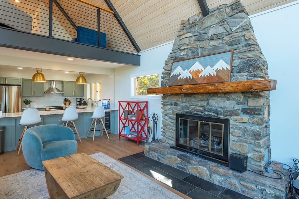 Living room with wood-burning fireplace, Smart TV (streaming and cable available).