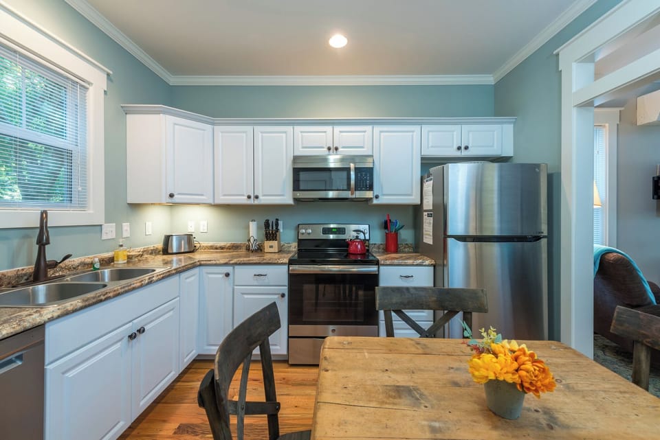 A modern kitchen featuring stainless steel appliances, granite countertops, and all the essentials needed for preparing home-cooked meals.