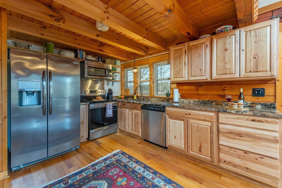 Kitchen with stainless appliances, dishwasher & standard drip coffeemaker.