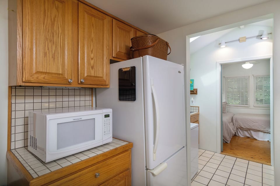 Kitchen with dishwasher, coffee grinder, and standard drip coffeemaker.