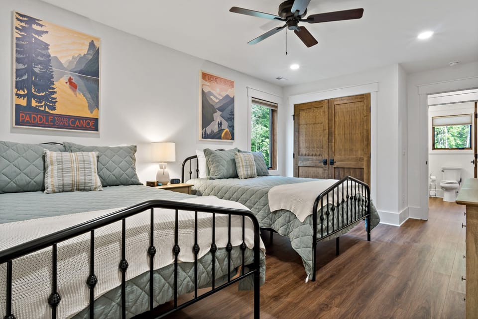 Upper-level bedroom with two queen-size beds and 45" Roku TV