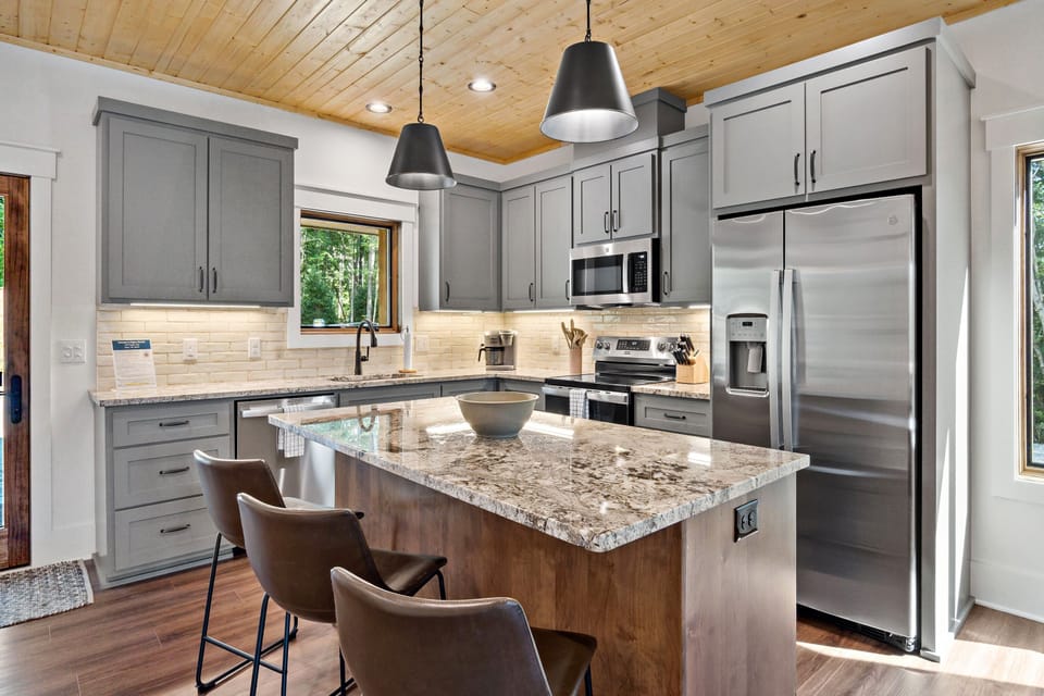 Well-equipped kitchen with island seating for 3, dishwasher, and combination drip-style and Keurig coffee maker