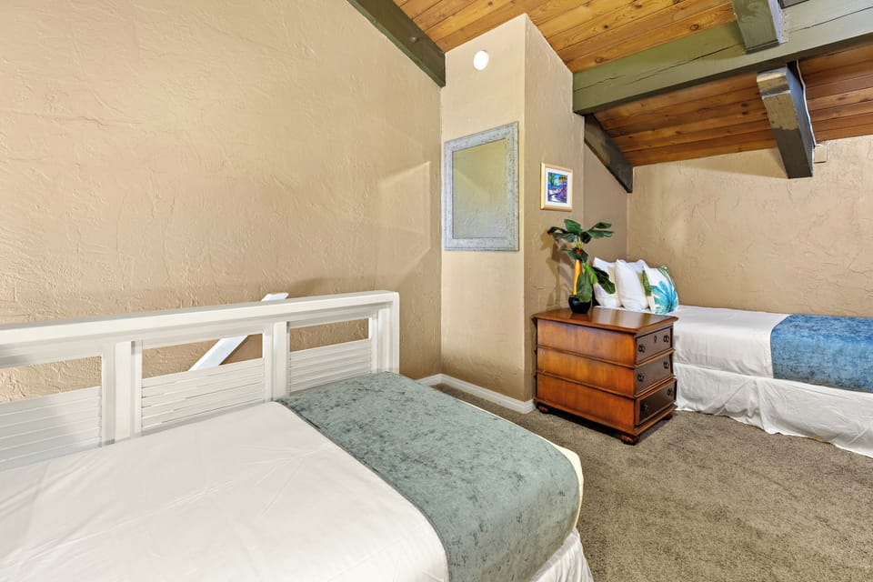 Loft bedroom with two twin beds and one queen size bed