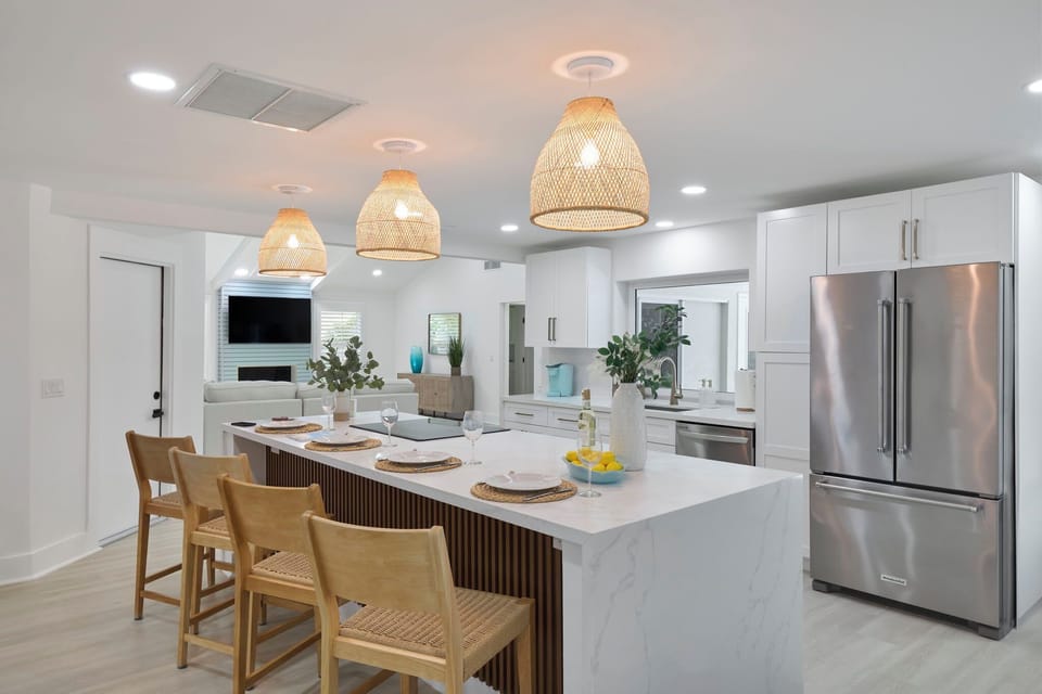 Fully equipped kitchen with breakfast bar and seating for four guests